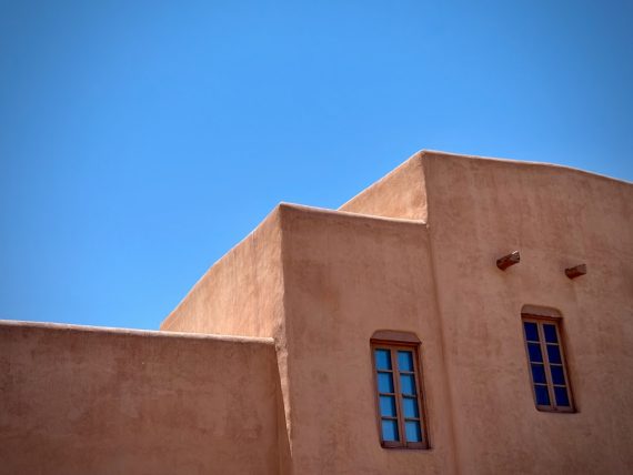 Adobe building against a bright blue sky.