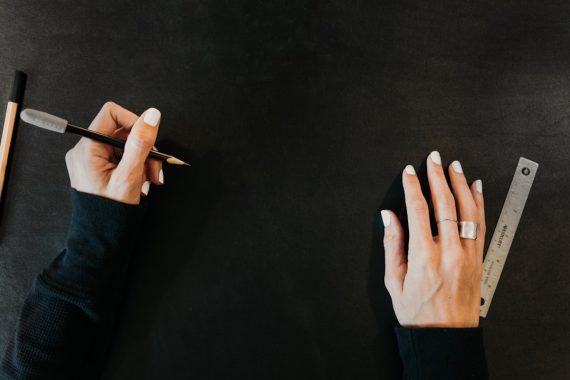 Hands on a large black surface