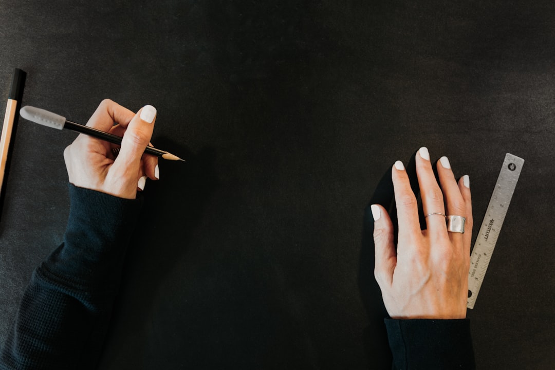 Hands on a large black surface