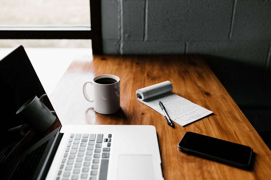 Laptop and notebook on a desk during a website platform decision