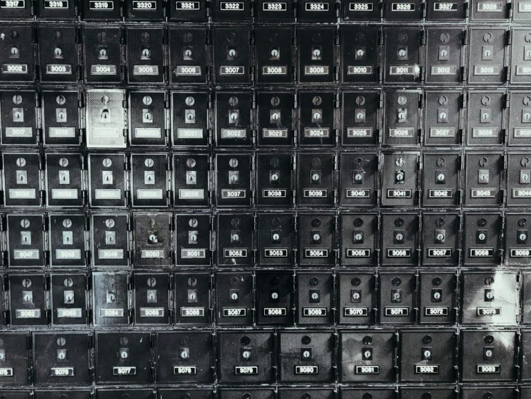 A grid of old metal post office boxes with brass doors