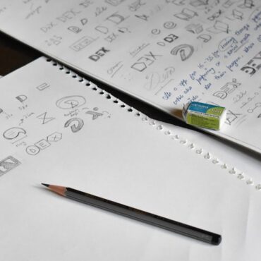a pencil sitting on top of a pile of paper
