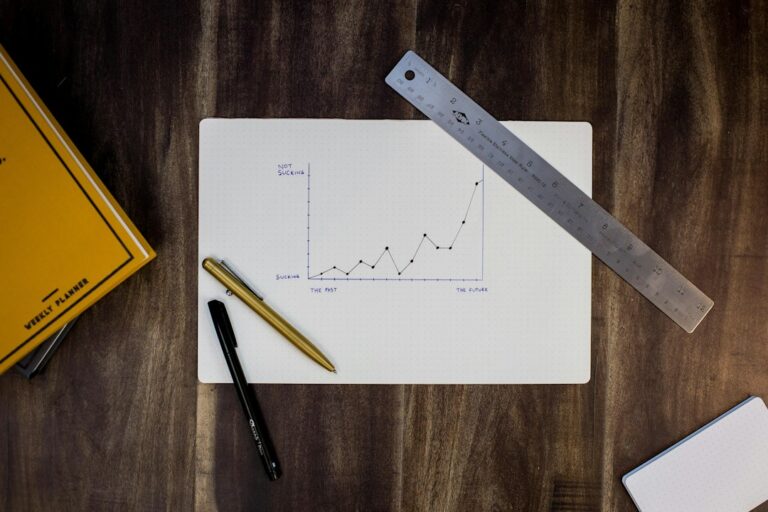 Printed website analytics charts and a notebook on a desk