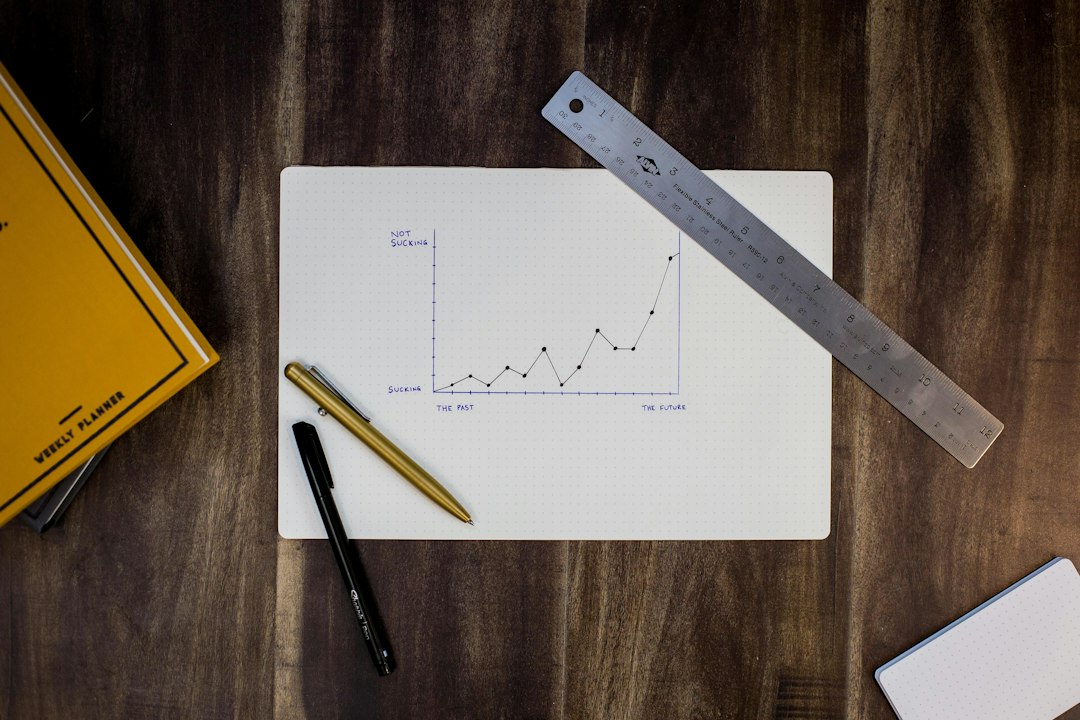 Printed website analytics charts and a notebook on a desk