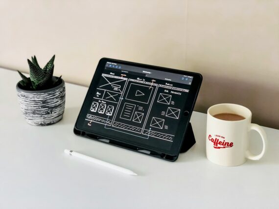 Website wireframe sketches and layout notes on a desk during a services page redesign