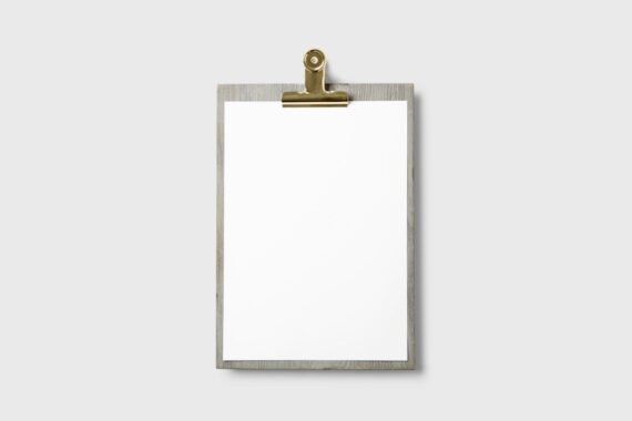 Blank paper form on a clipboard with a pen, representing website contact form fields