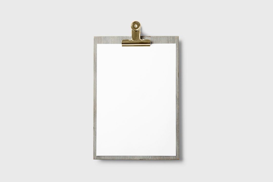 Blank paper form on a clipboard with a pen, representing website contact form fields
