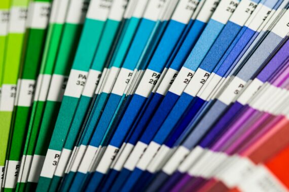 Fanned-out printed color swatch guide used to specify brand colors for press and signage
