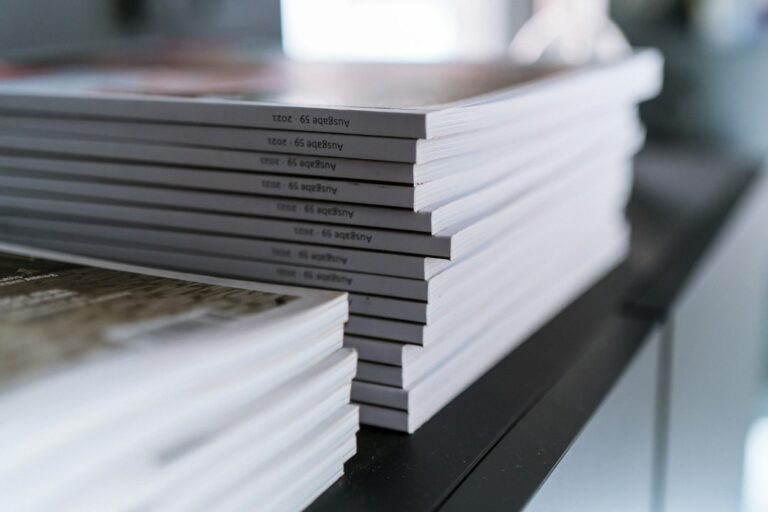 Printed pages of a project write-up spread across a desk